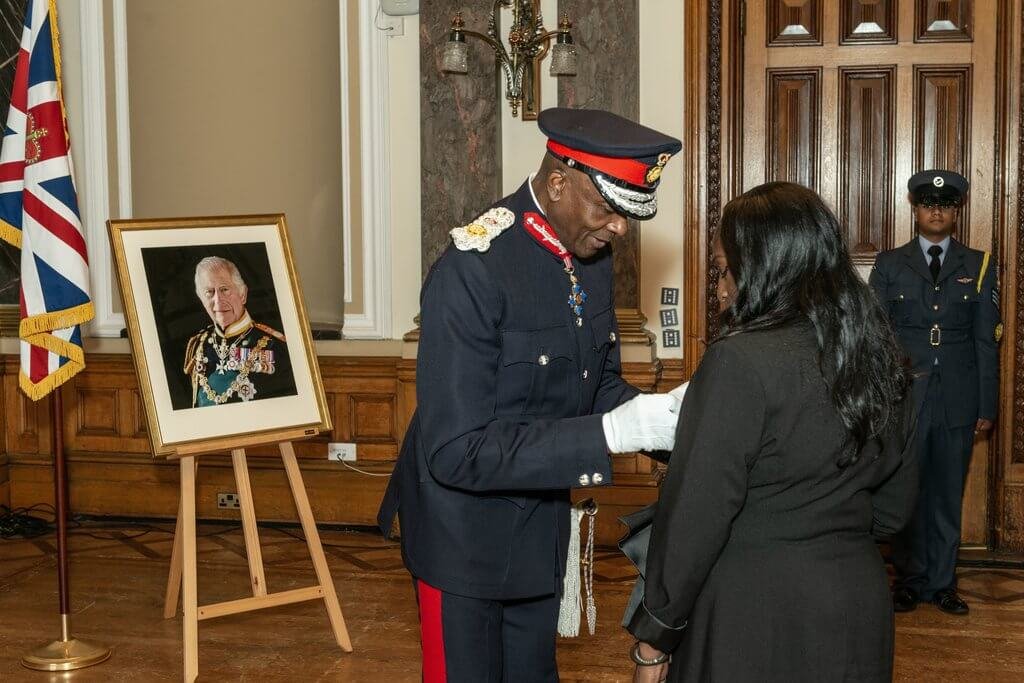 Caron receiving her award from the Lord Lieutenant Derrick Anderson CBE